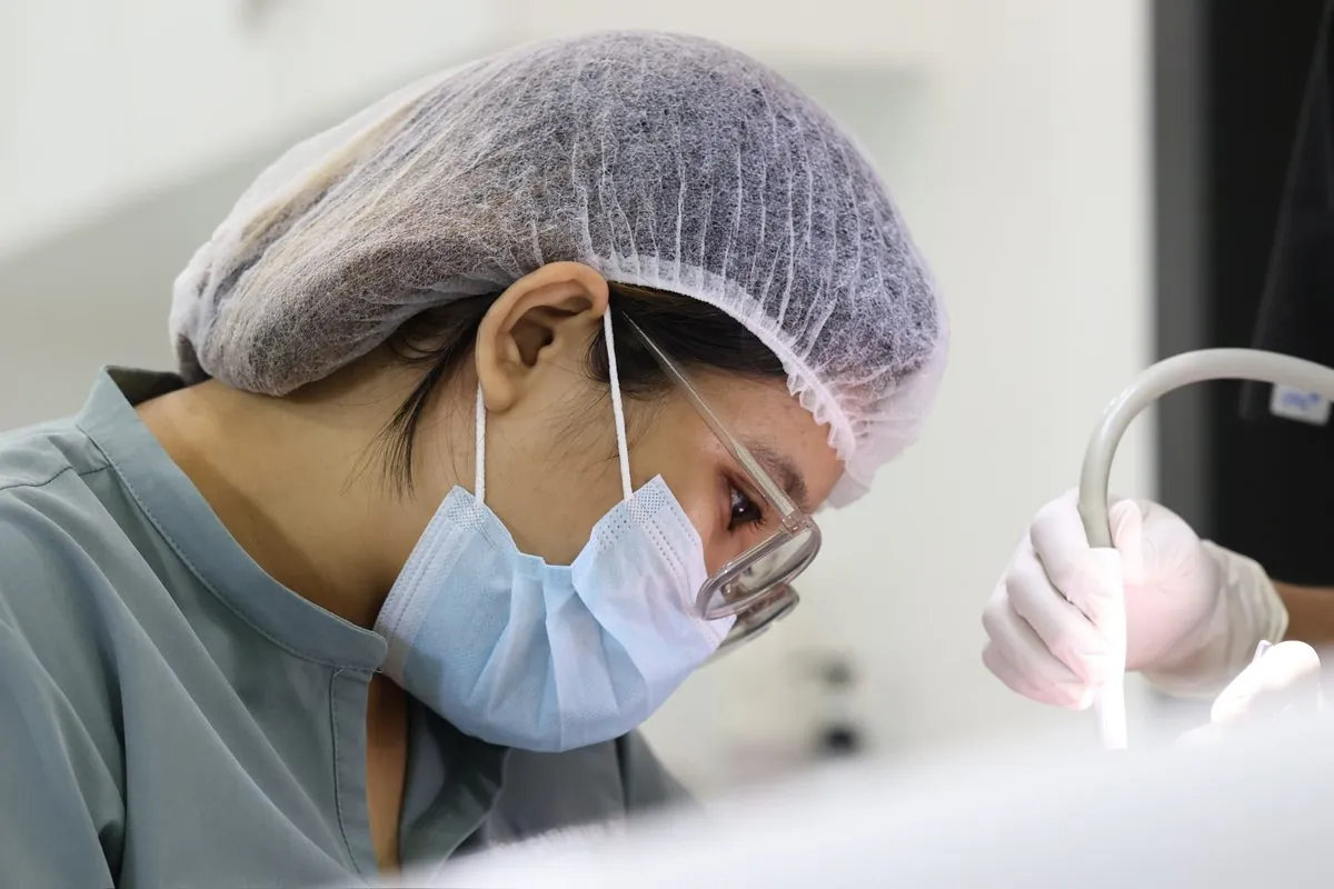 MDN dentist working carefully on a patient's teeth